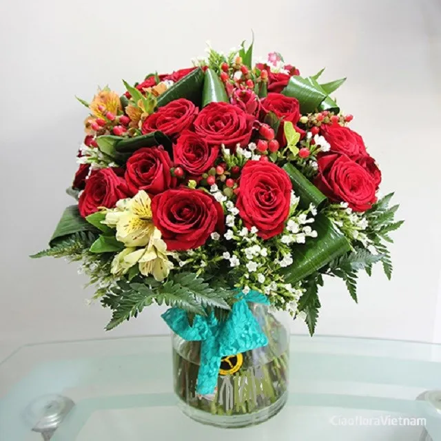 Red roses and seasonal flowers in vase - Vietnam