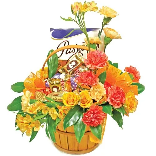 Composition golden summer, composition of orange flowers, carnation, roses, decorative green, composition in a wooden basket with chocolate 