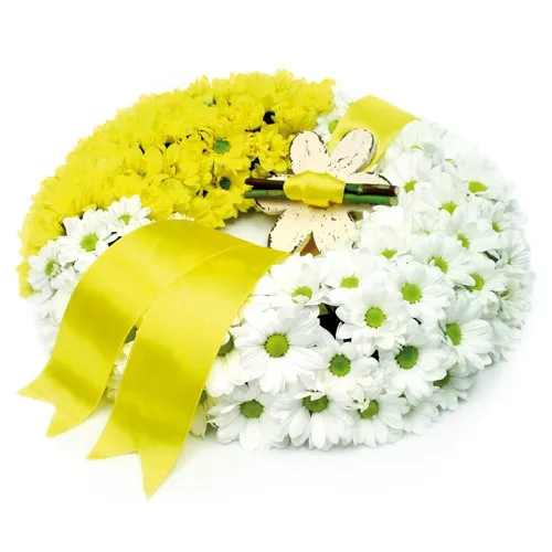 Wreath made of colourful oxeye daisies and bow will solemnly bid farewell to the deceased