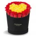 Red and yellow roses heart shaped in a black box