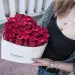 Red roses in a white heart shaped box