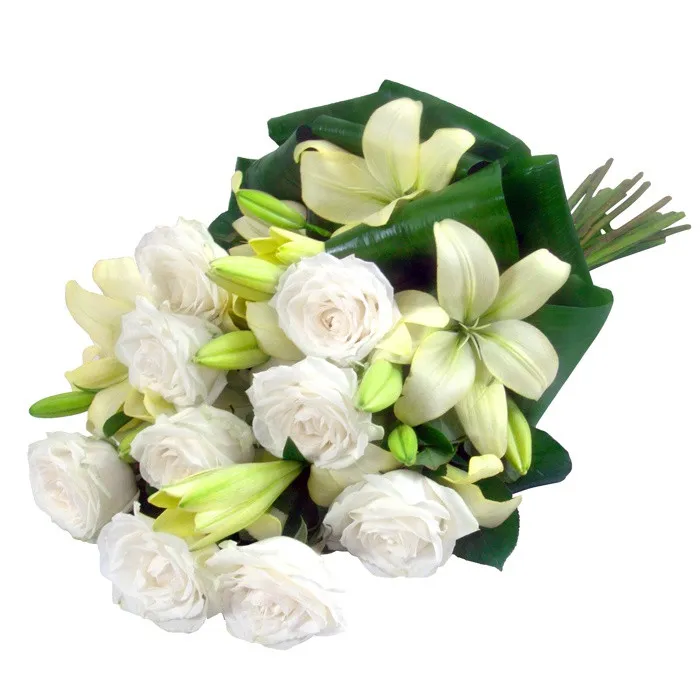 Flowers Delicate white wreath of condolences, white roses and lilies in funeral wreath 