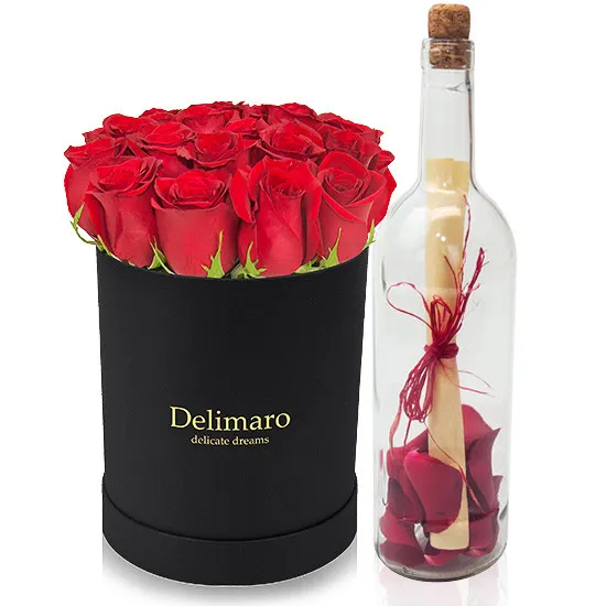 Flowerbox with letter in a bottle, letter with rose petals in bottle, red roses in black box