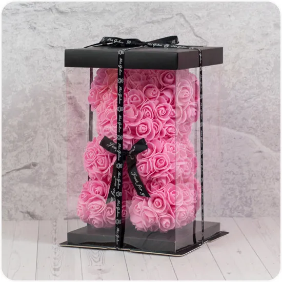 teddy bear with roses in a plastic box with a black ribbon for a gift