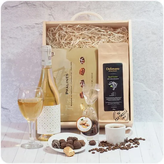 An engraved golden box, a wooden gift box with white wine and coffee beans, ginger in chocolate
