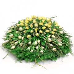 Funeral wreath with tulips, white and yellow tulips with greenery for funerals