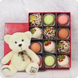 Strawberries in chocolate with macaroons and teddy bear